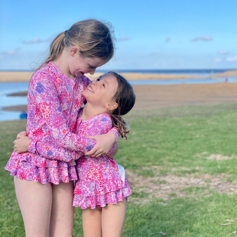 sisters wearing matching ocean tales cossies